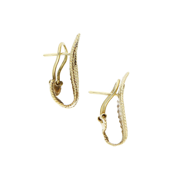 Aretes estilizados con diamantes en oro amarillo 14 kilates.