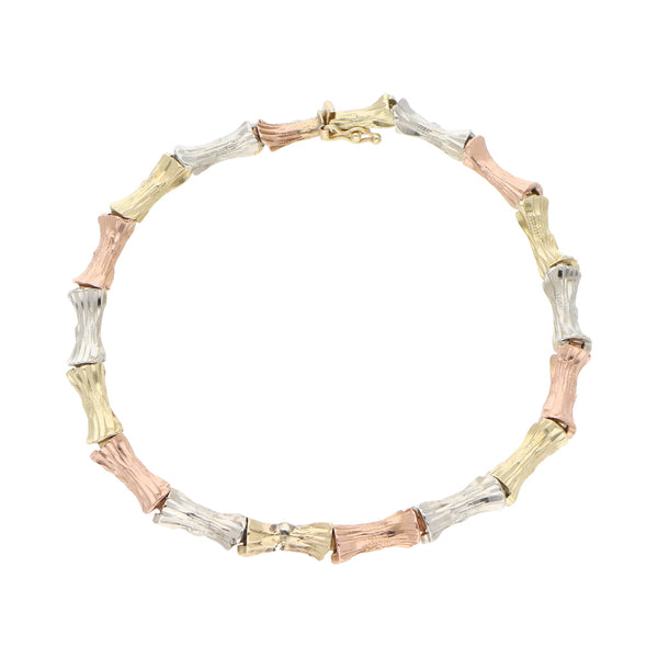 Pulsera eslabón articulado en oro tres tonos 14 kilates.