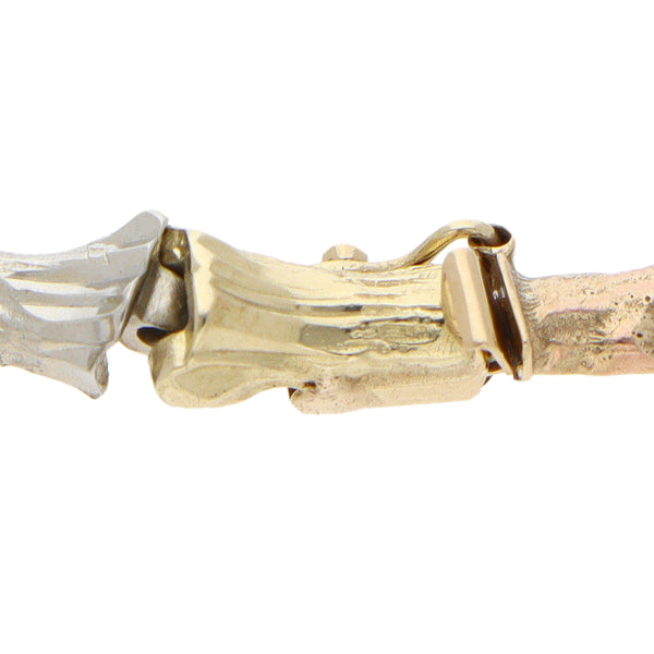 Pulsera eslabón articulado en oro tres tonos 14 kilates.