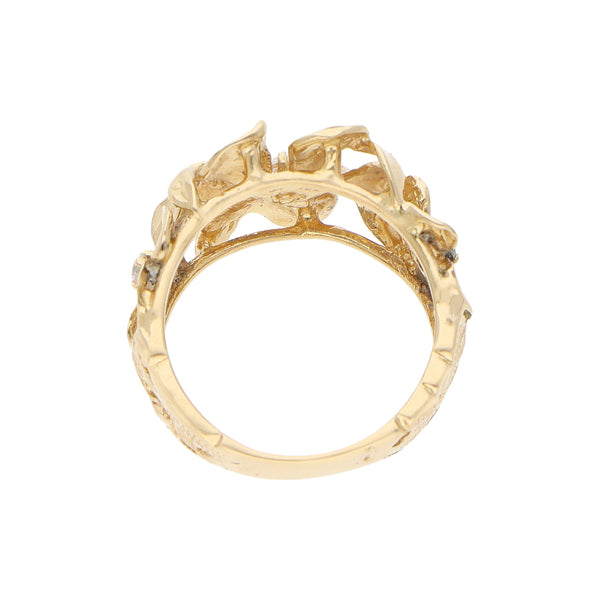 Anillo calado motivo floral con circonias en oro amarillo 14 kilates.