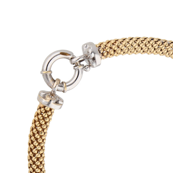 Pulsera eslabón laminado con aplicación motivo corazón en oro dos tonos 14 kilates.