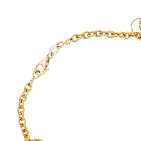 Pulsera eslabón cruzado con colgantes y sintéticos en oro amarillo 14 kilates.