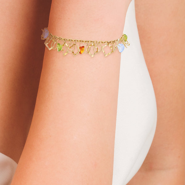 Pulsera eslabón cruzado con colgantes y sintéticos en oro amarillo 14 kilates.