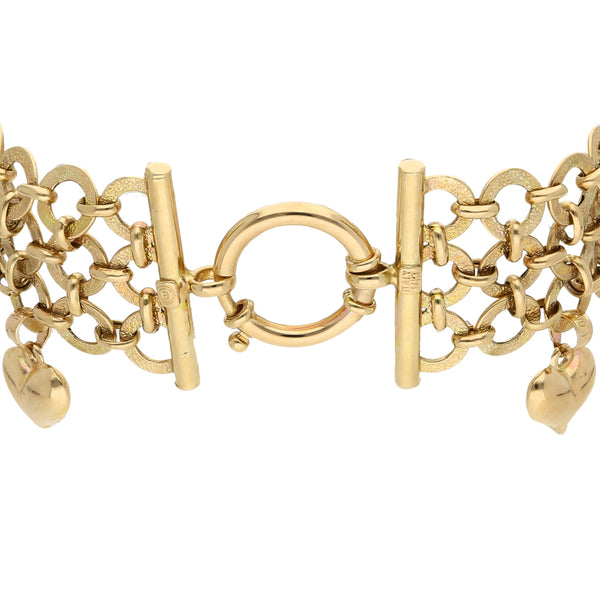 Pulsera eslabón combinado con colgantes motivo corazón en oro amarillo 14 kilates.