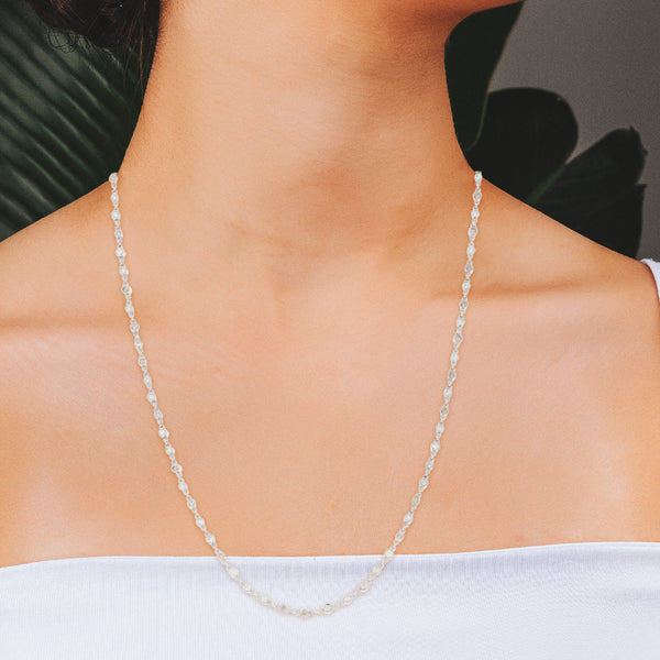 Juego de collar y pulsera eslabón cruzado con diamantes en oro blanco 18 kilates.