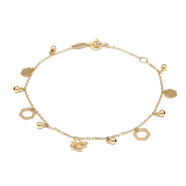 Pulsera eslabón cruzado con colgantes motivo panal y abeja en oro amarillo 14 kilates.