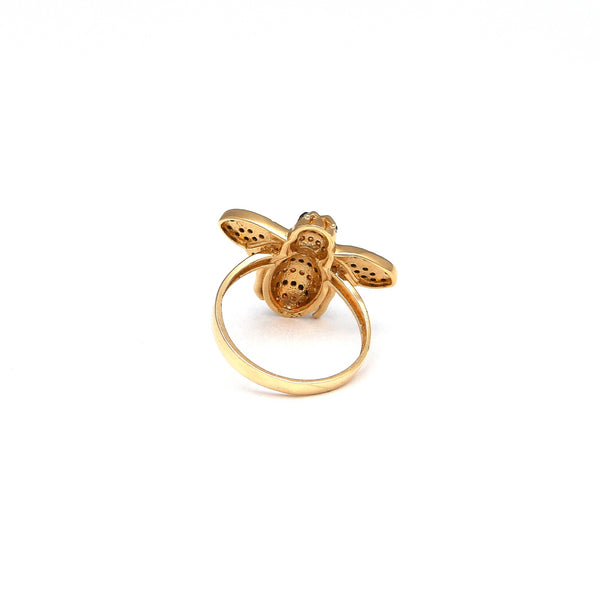 Anillo estilizado motivo abeja con sintéticos en oro amarillo 14 kilates.