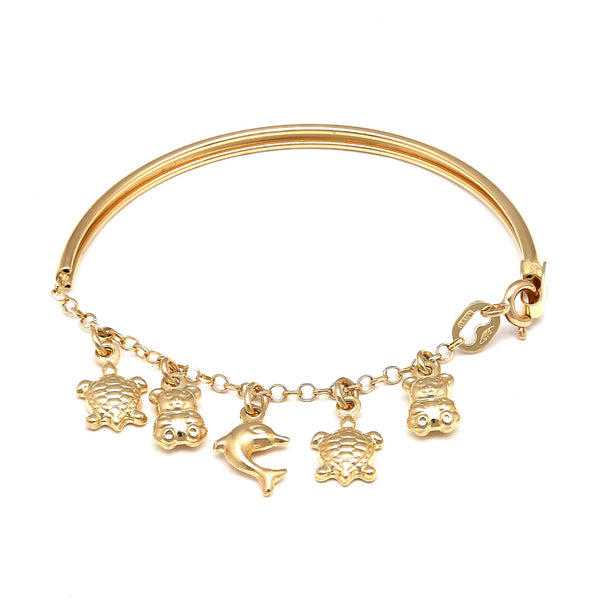 Pulsera infantil eslabón cruzado con aplicación, colgantes motivo tortugas, osos y delfín en oro amarillo 14 kilates.