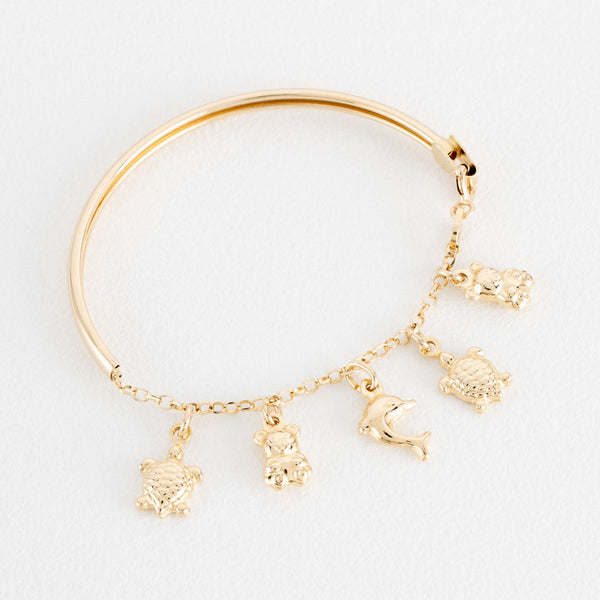 Pulsera infantil eslabón cruzado con aplicación, colgantes motivo tortugas, osos y delfín en oro amarillo 14 kilates.