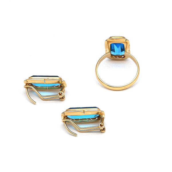 Juego de anillo y aretes diseño especial con topacios London blue en oro amarillo 14 kilates.