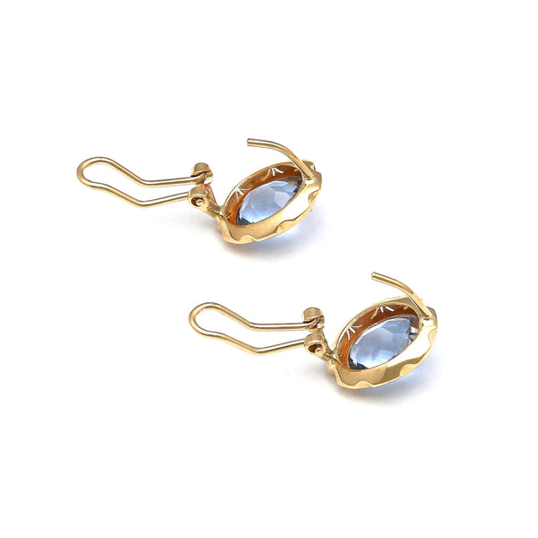 Juego de anillo y aretes calados con topacios azules en oro amarillo 14 kilates.