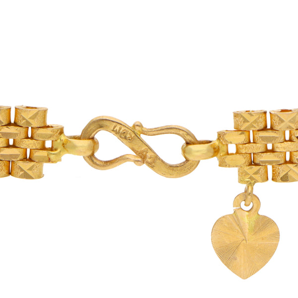 Pulsera eslabón articulado combinado con colgante motivo corazón en oro amarillo 22 kilates.