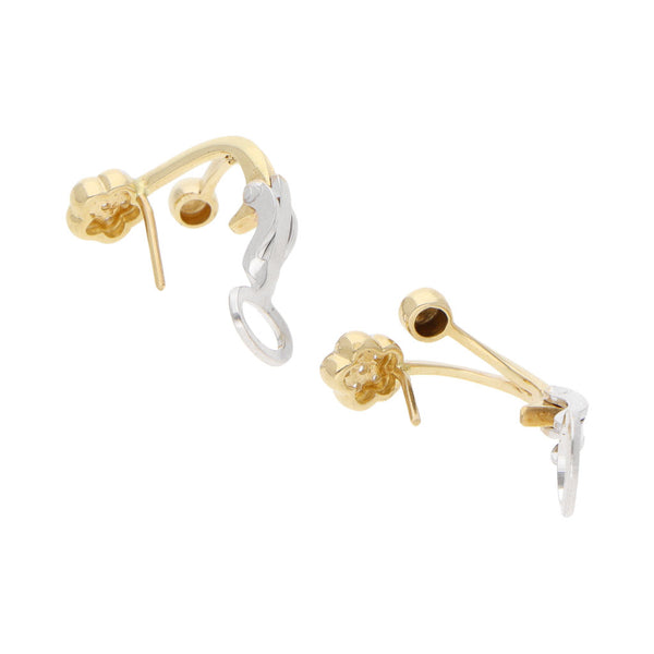 Aretes estilizados motivo floral con circonias en oro dos tonos 14 kilates.