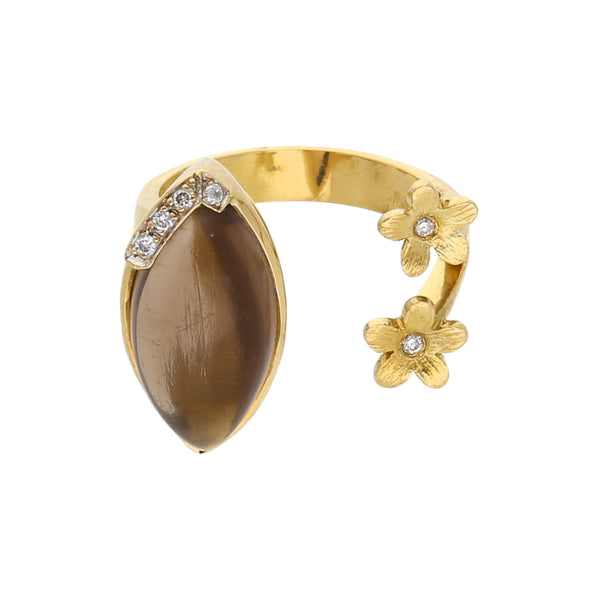 Anillo abierto con diamantes y topacio en oro amarillo 18 kilates.