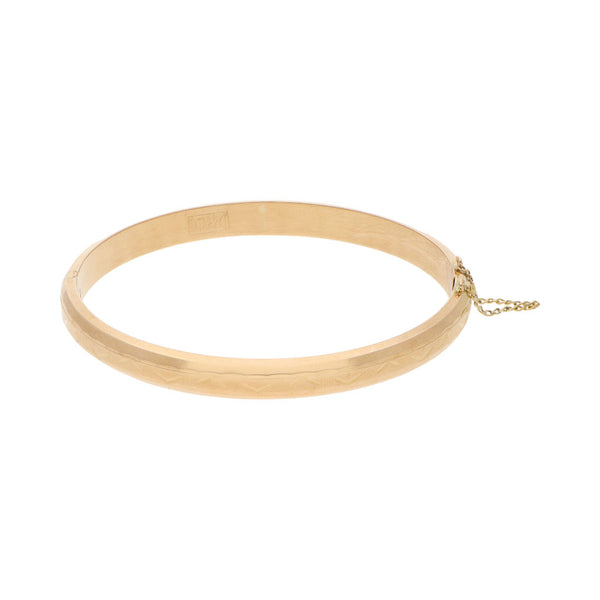 Pulsera de arillo labrada en oro amarillo 18 kilates.