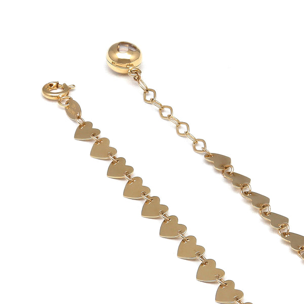 Pulsera eslabón combinado motivo corazones en oro amarillo 14 kilates.