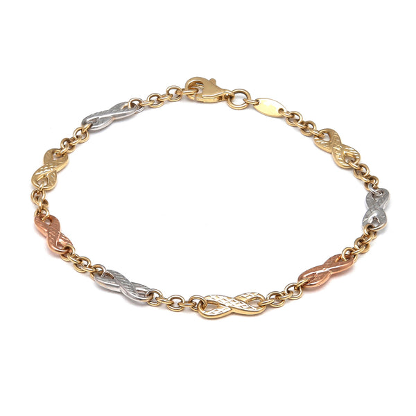 Pulsera eslabón combinado motivo infinitos en oro tres tonos 14 kilates.