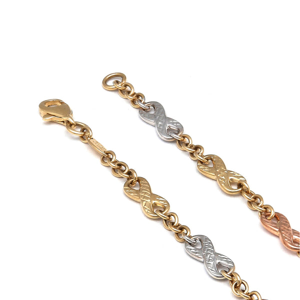 Pulsera eslabón combinado motivo infinitos en oro tres tonos 14 kilates.