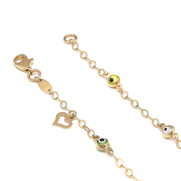 Pulsera eslabón cruzado con aplicaciones motivo ojo, colgante motivo corazón y sintéticos en oro amarillo 14 kilates.