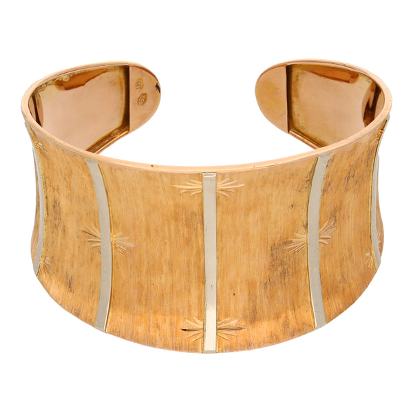 Brazalete abierto laminado en oro dos tonos 18 kilates.