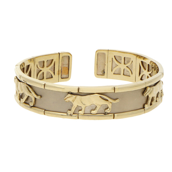Pulsera de arillo ovalada abierta motivo felinos en oro dos tonos 14 kilates.