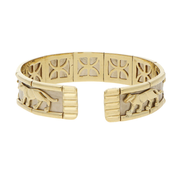 Pulsera de arillo ovalada abierta motivo felinos en oro dos tonos 14 kilates.