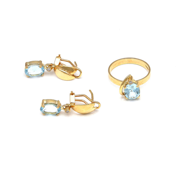 Juego de anillo y aretes estilizados con diamantes y topacios sky blue en oro amarillo 14 kilates.