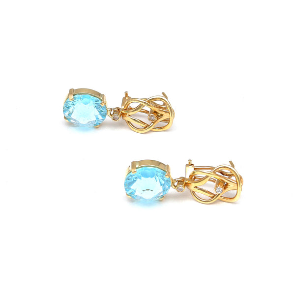 Aretes articulados con diamantes y topacio azul en oro amarillo 14 kilates.