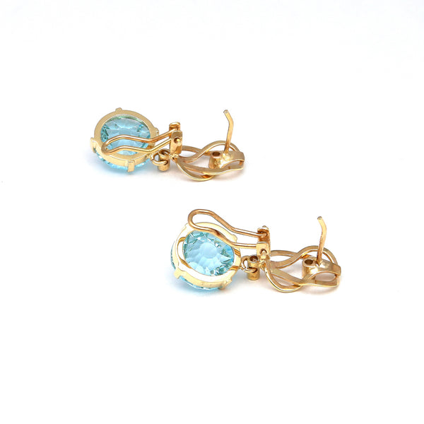 Aretes articulados con diamantes y topacio azul en oro amarillo 14 kilates.