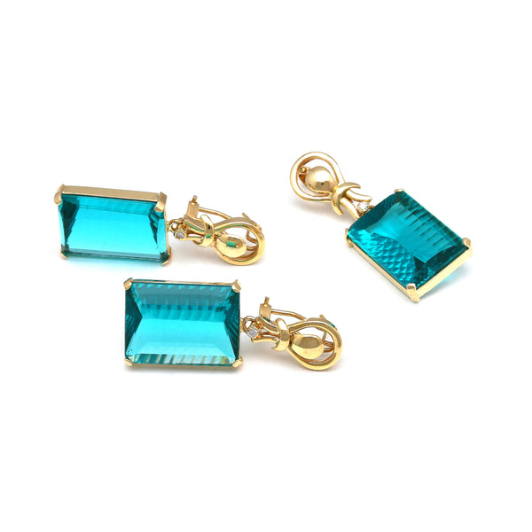 Juego aretes y dije estilizados con diamantes y obsidiana paraiba en oro amarillo 14 kilates.