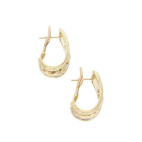 Aretes estilizados motivo felino en oro amarillo 14 kilates.