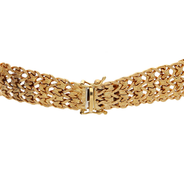 Pulsera eslabón tejido con aplicación y diamantes en oro amarillo 18 kilates.