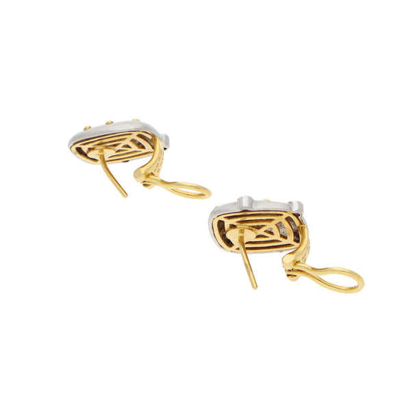 Aretes estilizados con diamantes en platino 950 y oro amarillo 18 kilates.