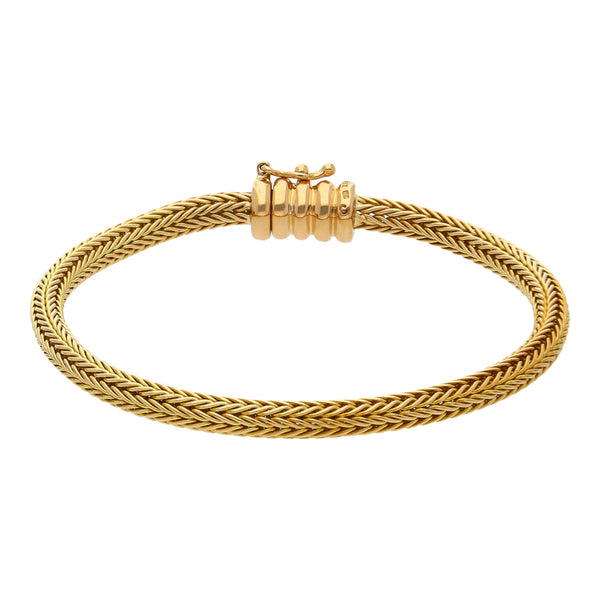 Pulsera eslabón tejido firma Tane en oro amarillo 18 kilates.