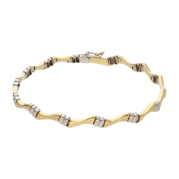 Pulsera eslabón articulado combinado en oro dos tonos 14 kilates.
