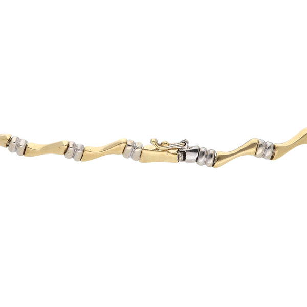 Pulsera eslabón articulado combinado en oro dos tonos 14 kilates.