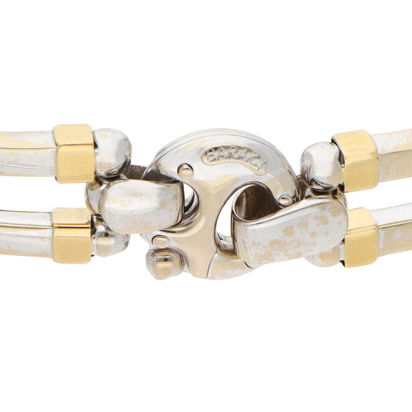 Pulsera eslabón articulado combinado con aplicación en oro dos tonos 18 kilates.