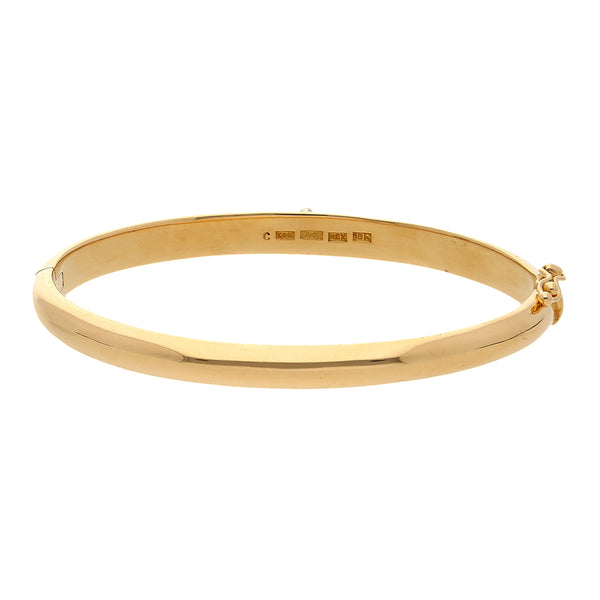 Pulsera ovalada articulada con aplicación firma Tane en oro amarillo 18 kilates.
