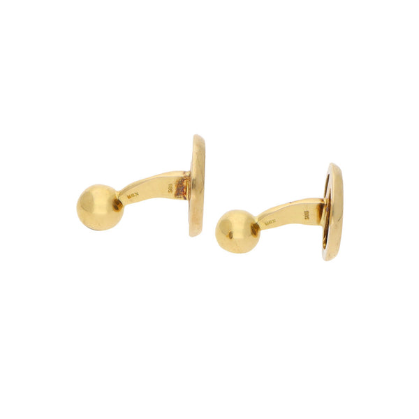 Mancuernillas diseño especial firma Tane con aplicaciones de plata en oro amarillo 18 kilates.