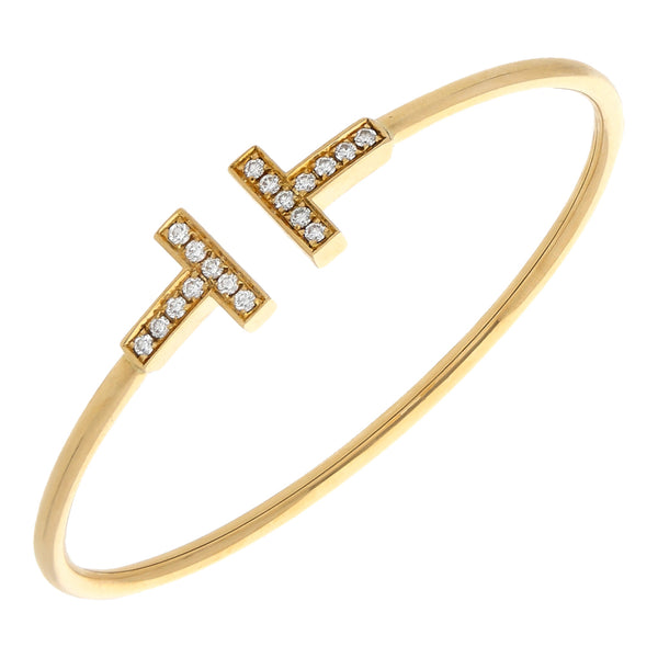 Pulsera de arillo ovalada abierta con aplicaciones y diamantes firma Tiffany & Co. en oro amarillo 18 kilates.