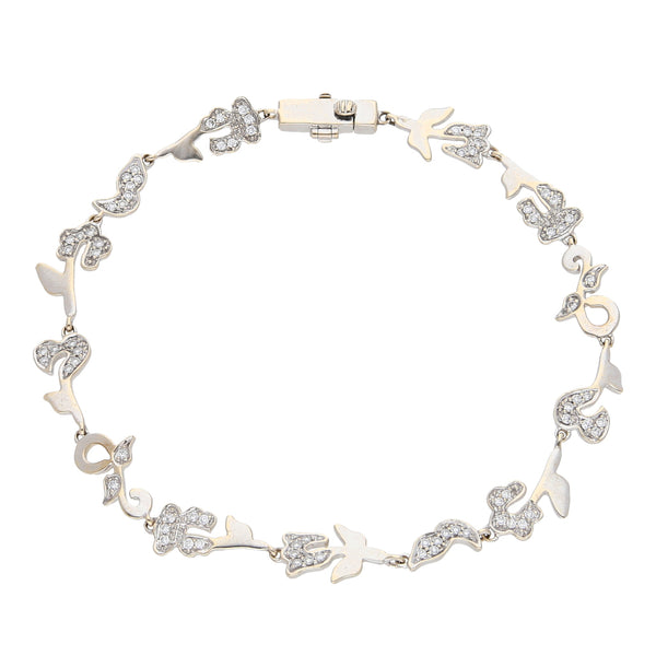 Pulsera eslabón cruzado combinado motivo floral con diamantes firma Tous en oro blanco 18 kilates.