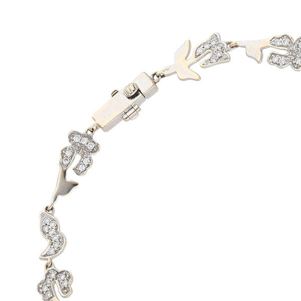 Pulsera eslabón cruzado combinado motivo floral con diamantes firma Tous en oro blanco 18 kilates.