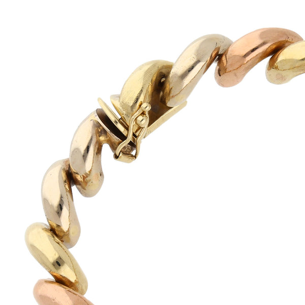 Pulsera eslabón articulado en oro tres tonos 14 kilates.