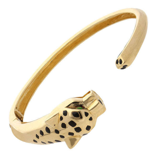 Pulsera articulada abierta motivo felino con esmalte en oro amarillo 14 kilates.