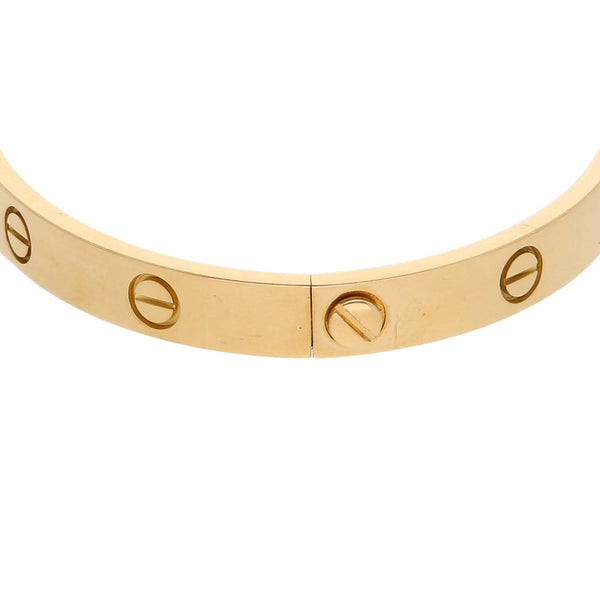 Pulsera rígida articulada motivo tornillos simulados firma Cartier en oro amarillo 18 kilates.