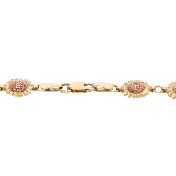 Pulsera eslabón combinado motivo girasoles en oro dos tonos 14 kilates.