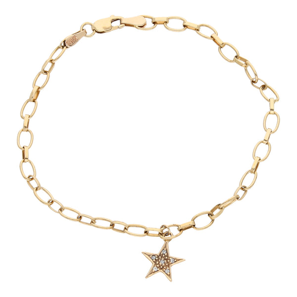 Pulsera eslabón cruzado combinado con dije motivo estrella y circonias en oro amarillo 14 kilates.