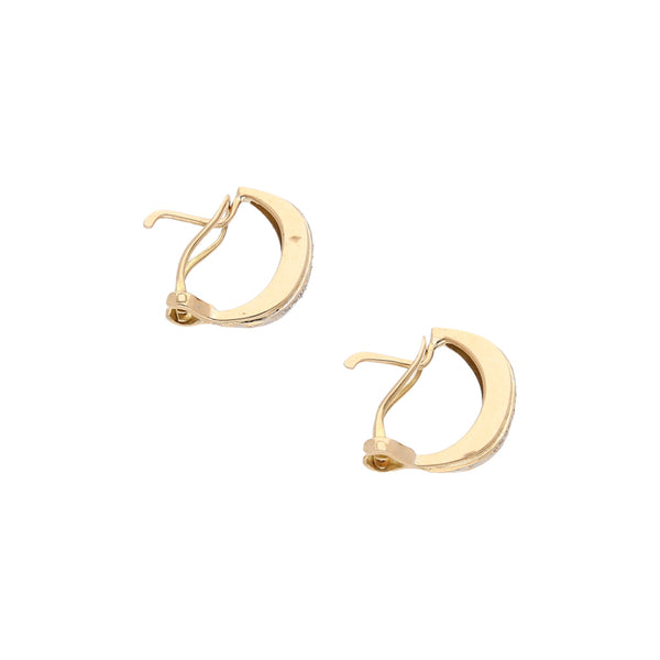 Aretes estilizados con circonias en oro amarillo 14 kilates.