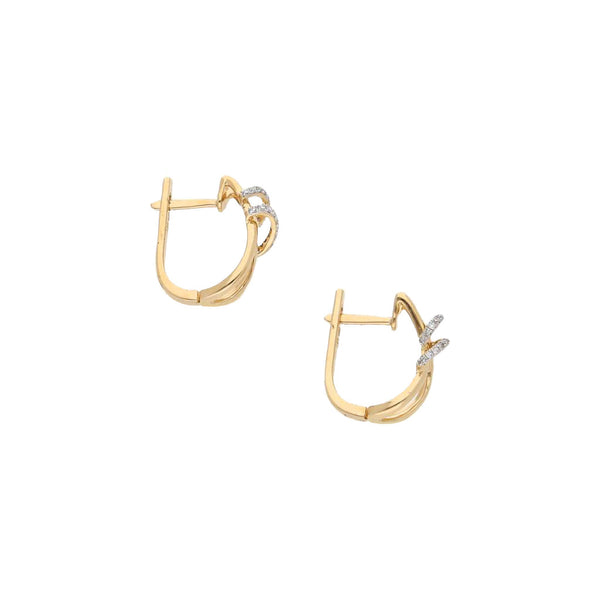 Aretes estilizados con diamantes en oro amarillo 14 kilates.