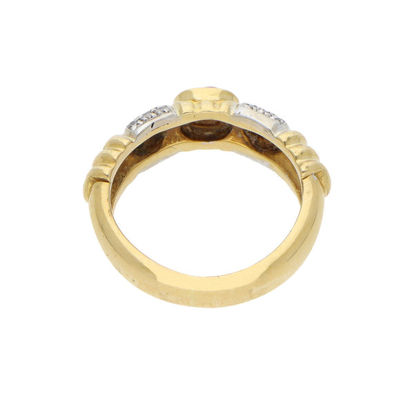 Anillo acanalado con diamantes y rubí en oro amarillo 18 kilates.